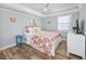 Cozy bedroom featuring a ceiling fan, bright paisley bedding, and light walls at 1356 Glenns Bay Rd. # 208M, Surfside Beach, SC 29575