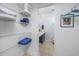 Well-organized walk-in closet leading to a functional bathroom at 1356 Glenns Bay Rd. # 208M, Surfside Beach, SC 29575