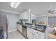 Modern kitchen with stainless steel appliances, white cabinets, and an open view to the living room at 1356 Glenns Bay Rd. # 208M, Surfside Beach, SC 29575