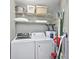 A tidy laundry room equipped with washer, dryer, shelves, and other supplies at 1356 Glenns Bay Rd. # 208M, Surfside Beach, SC 29575