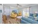 Open-concept living room with stylish furniture, including yellow chairs, a blue sofa, and coastal accents at 1356 Glenns Bay Rd. # 208M, Surfside Beach, SC 29575