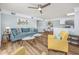 Inviting living room with a blue sofa, ceiling fan, and open floor plan flowing into the dining area and kitchen at 1356 Glenns Bay Rd. # 208M, Surfside Beach, SC 29575