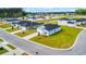 Aerial view of a modern, well-maintained home in a vibrant, green neighborhood setting at 1368 Palm Springs Paloma Dr, Longs, SC 29568