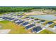 Aerial view showcasing new homes within the community, nestled amongst lush greenery and serene ponds at 1368 Palm Springs Paloma Dr, Longs, SC 29568