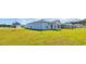 Spacious backyard showing the home's exterior with light blue siding and ample lawn space at 1368 Palm Springs Paloma Dr, Longs, SC 29568
