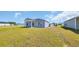 Large backyard with a covered patio, green lawn, and blue siding home exterior at 1368 Palm Springs Paloma Dr, Longs, SC 29568