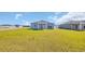 Expansive backyard with a view of the home's exterior, including the covered patio and windows at 1368 Palm Springs Paloma Dr, Longs, SC 29568