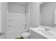 Neutral bathroom featuring a tub, toilet, white vanity and wood-look flooring at 1368 Palm Springs Paloma Dr, Longs, SC 29568