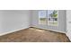 Bright bedroom with hardwood flooring and natural light streaming through two windows at 1368 Palm Springs Paloma Dr, Longs, SC 29568