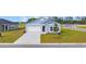Charming single Gathering home with blue siding, manicured lawn and a concrete driveway at 1368 Palm Springs Paloma Dr, Longs, SC 29568