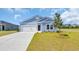 Charming single Gathering home with blue siding, manicured lawn and a concrete driveway at 1368 Palm Springs Paloma Dr, Longs, SC 29568