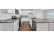 Bright kitchen with white cabinetry, granite countertops, and stainless steel appliances at 1368 Palm Springs Paloma Dr, Longs, SC 29568