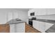 Kitchen featuring granite countertops, stainless appliances, white cabinets and wood-look floors at 1368 Palm Springs Paloma Dr, Longs, SC 29568