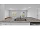 Spacious kitchen featuring granite countertop and stainless sink with view of living area at 1368 Palm Springs Paloma Dr, Longs, SC 29568