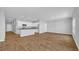 Open concept living space with updated kitchen and wood-look flooring at 1368 Palm Springs Paloma Dr, Longs, SC 29568