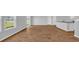 Open-concept living room featuring wood-look flooring, natural light and neutral color palette at 1368 Palm Springs Paloma Dr, Longs, SC 29568