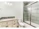 Bathroom featuring a vanity with marble countertop and decorative knobs, next to tiled shower at 1400 James Island Ave., North Myrtle Beach, SC 29582