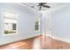 Bright bedroom with hardwood floors, two windows offering natural light, and crown molding at 1400 James Island Ave., North Myrtle Beach, SC 29582