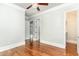 Bedroom with hardwood floors, ceiling fan and multiple entry doors, offering versatile space at 1400 James Island Ave., North Myrtle Beach, SC 29582