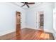 Light-filled bedroom featuring hardwood floors, tray ceiling, and access to an ensuite bathroom at 1400 James Island Ave., North Myrtle Beach, SC 29582