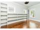 Spacious bonus room with wall-to-wall shelving, offering tons of storage, and bright windows at 1400 James Island Ave., North Myrtle Beach, SC 29582