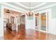 Open dining area showcasing a chandelier, view to a modern kitchen, and access to a wood-paneled porch at 1400 James Island Ave., North Myrtle Beach, SC 29582