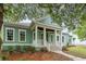 Charming home with a welcoming front porch featuring white columns and a well-manicured lawn at 1400 James Island Ave., North Myrtle Beach, SC 29582