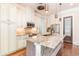 Elegant kitchen featuring custom cabinets, stainless steel appliances, and a granite-topped island with breakfast bar at 1400 James Island Ave., North Myrtle Beach, SC 29582