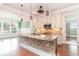 Spacious kitchen with a center island featuring stone accents, stainless appliances, and pendant lighting at 1400 James Island Ave., North Myrtle Beach, SC 29582