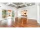 Open-concept living room with hardwood floors, coffered ceilings, and seamless access to kitchen and outdoor space at 1400 James Island Ave., North Myrtle Beach, SC 29582