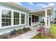 Side view of the home's patio with charming lights, a small table, and beautiful landscaping at 1400 James Island Ave., North Myrtle Beach, SC 29582