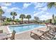 Relaxing pool area featuring palm trees, comfortable lounge chairs, and a serene atmosphere at 1400 James Island Ave., North Myrtle Beach, SC 29582
