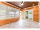 Inviting wood-paneled porch with tile floors and multiple windows providing ample natural light at 1400 James Island Ave., North Myrtle Beach, SC 29582