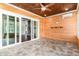 Cozy wood-paneled porch with tile floor, ceiling fan, and sliding glass doors to the interior at 1400 James Island Ave., North Myrtle Beach, SC 29582