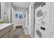 Modern bathroom with stacked washer and dryer, complemented by stylish fixtures and interior design at 142 Ella Kinley Circle # 402, Myrtle Beach, SC 29588