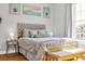 Comfortable bedroom with tufted headboard, soft lighting, and beach-themed decor for a serene retreat at 142 Ella Kinley Circle # 402, Myrtle Beach, SC 29588