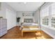 Bright bedroom showcasing hardwood floors, natural light, and coastal artwork, creating a tranquil atmosphere at 142 Ella Kinley Circle # 402, Myrtle Beach, SC 29588