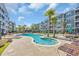 Community pool surrounded by palm trees and patio furniture, offering a resort-style living experience at 142 Ella Kinley Circle # 402, Myrtle Beach, SC 29588