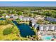 Aerial view showcases community's lake, resort amenities, and surrounding green spaces at 14290 Ocean Highway # 222, Pawleys Island, SC 29585