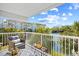Inviting balcony with comfortable seating overlooking lush tropical landscaping and serene waterfront views at 14290 Ocean Highway # 222, Pawleys Island, SC 29585