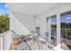 Cozy balcony setting with a glass table and chairs, offering a serene outdoor seating area at 14290 Ocean Highway # 222, Pawleys Island, SC 29585