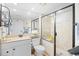Well-lit bathroom featuring a modern vanity, toilet, and walk-in shower with glass doors at 14290 Ocean Highway # 222, Pawleys Island, SC 29585