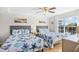 Bright bedroom featuring two beds with seashell patterned comforters and a serene waterfront view at 14290 Ocean Highway # 222, Pawleys Island, SC 29585