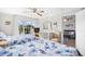 Spacious bedroom with two beds, ceiling fan, and view into the living room showcasing the interior layout at 14290 Ocean Highway # 222, Pawleys Island, SC 29585