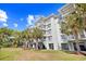 Building's facade featuring multiple floors, balconies, and well-maintained landscaping at 14290 Ocean Highway # 222, Pawleys Island, SC 29585
