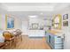 Charming kitchen with white cabinets, modern appliances, a dining table, and a kitchen island at 14290 Ocean Highway # 222, Pawleys Island, SC 29585