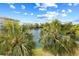 Picturesque view of a serene lake surrounded by palm trees and lush greenery, creating a tranquil atmosphere at 14290 Ocean Highway # 222, Pawleys Island, SC 29585