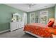 Bright bedroom with two windows, neutral carpet, ceiling fan, and orange accents throughout at 1470 Suncrest Dr., Myrtle Beach, SC 29577