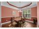 Formal dining room has an elegant chandelier and large window at 1470 Suncrest Dr., Myrtle Beach, SC 29577