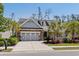Inviting home exterior showcasing a well-manicured lawn, decorative stone, and a two-car garage at 1470 Suncrest Dr., Myrtle Beach, SC 29577